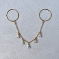 Gold keychain with hanging teardrop-shaped pendants on a light gray background