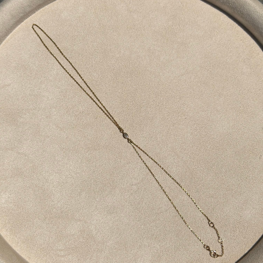 Necklace on a round beige cushion