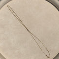 Necklace on a round beige cushion