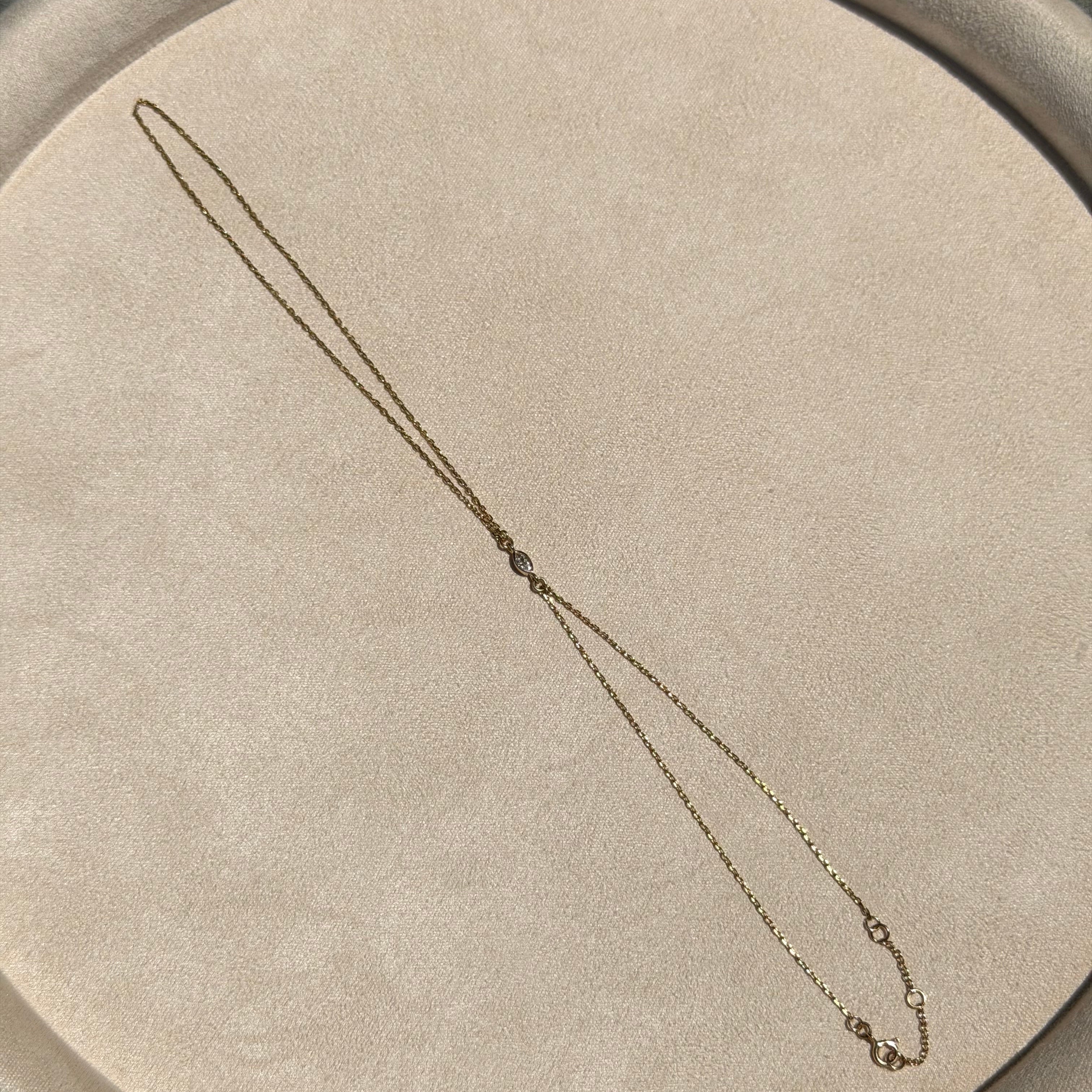 Necklace on a round beige cushion