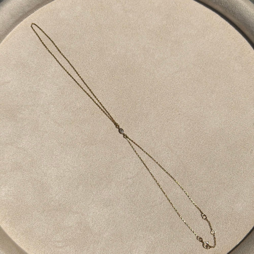 Necklace on a round beige cushion