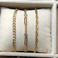 Gold and silver bracelets on a beige jewelry display box