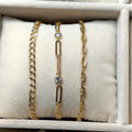 Gold and silver bracelets on a beige jewelry display box