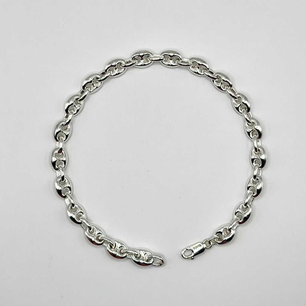 Silver chain bracelet on a light gray background