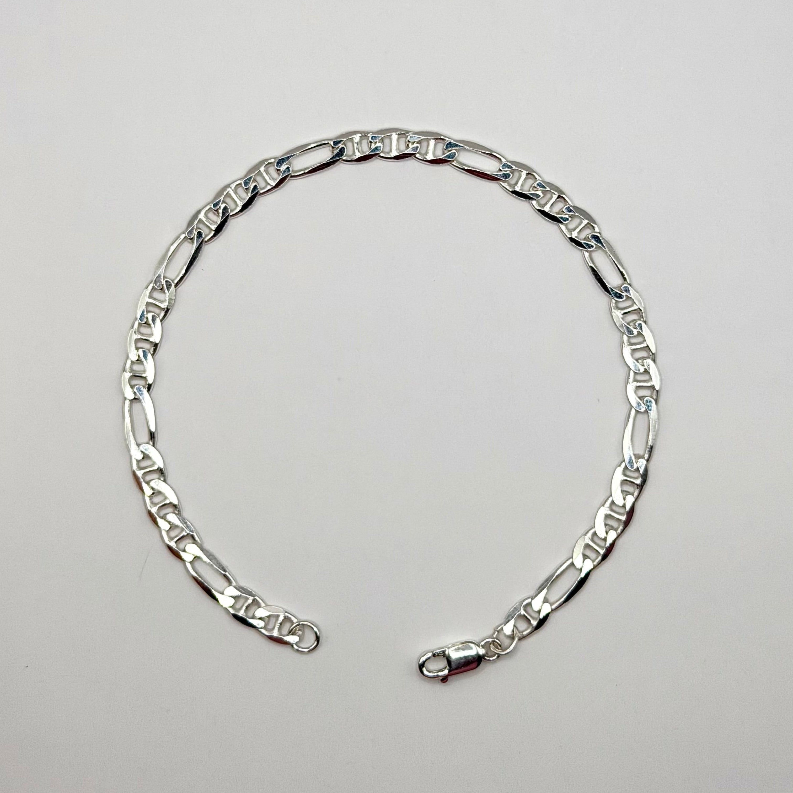 Silver chain bracelet on a light gray background