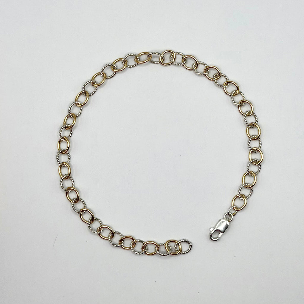 Silver chain bracelet on a light gray background
