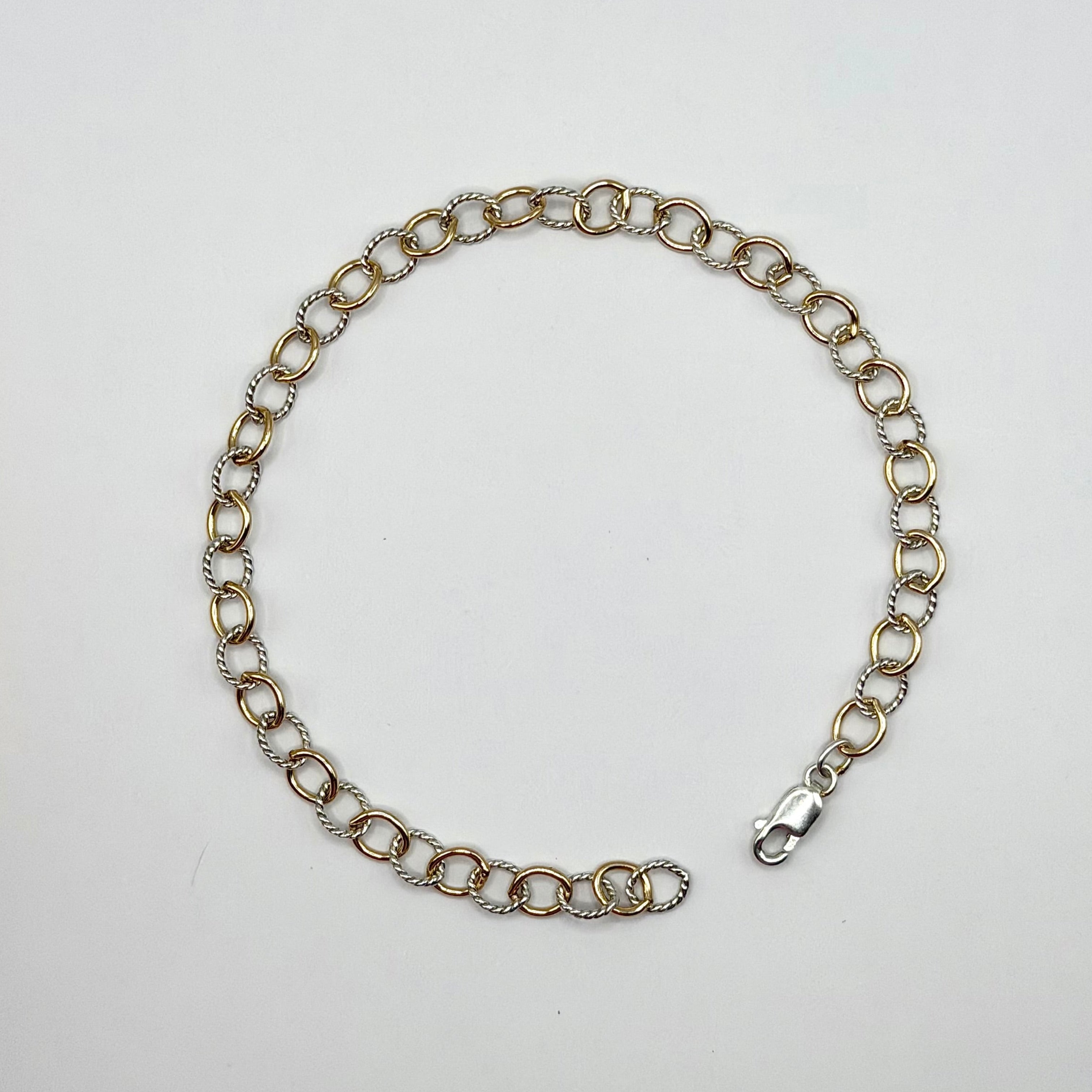 Silver chain bracelet on a light gray background