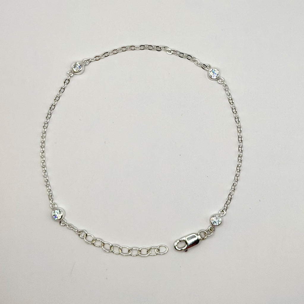 Silver bracelet on a light gray background