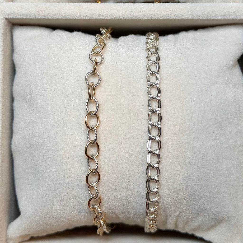 Three necklaces displayed on a textured surface