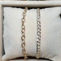 Three necklaces displayed on a textured surface