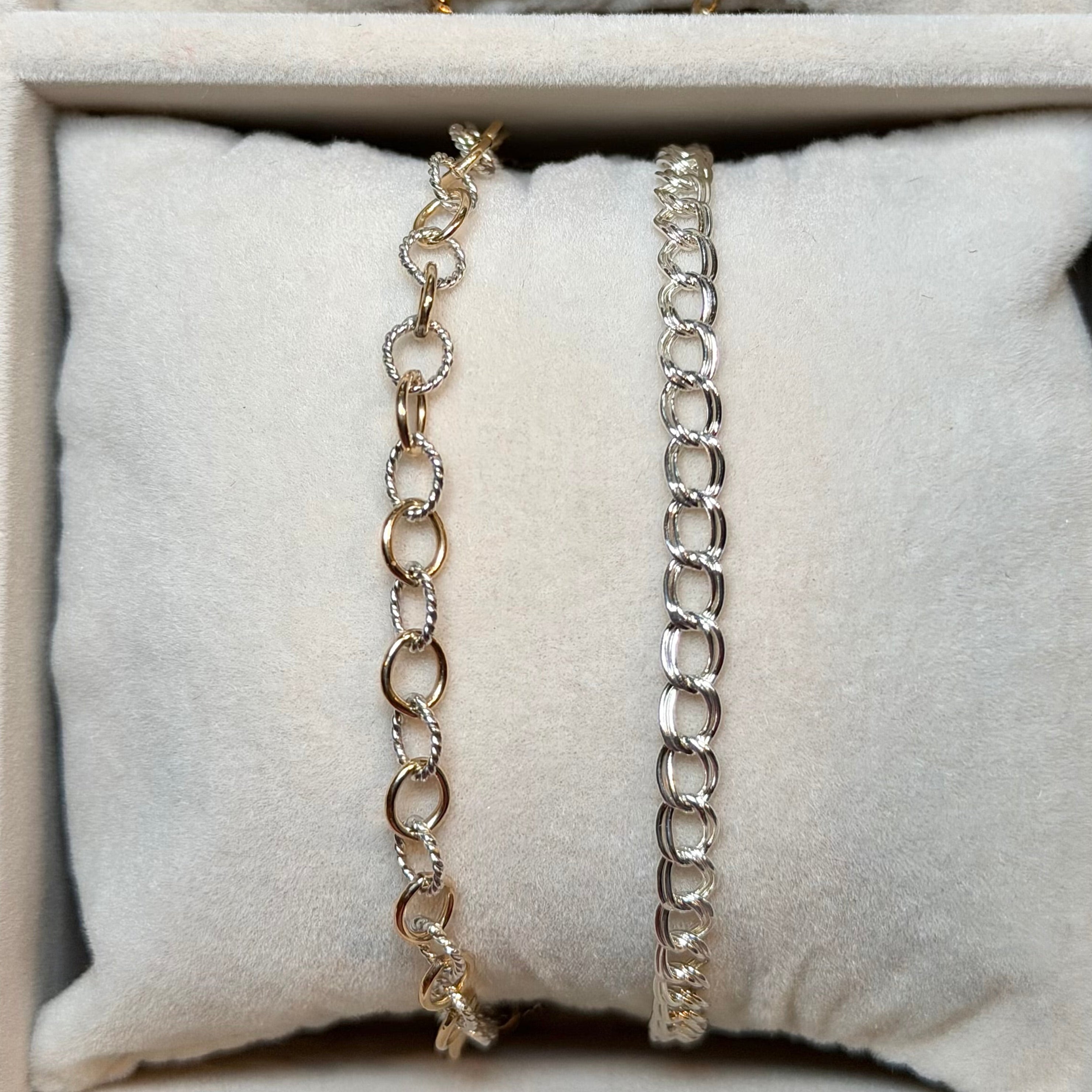 Three necklaces displayed on a textured surface